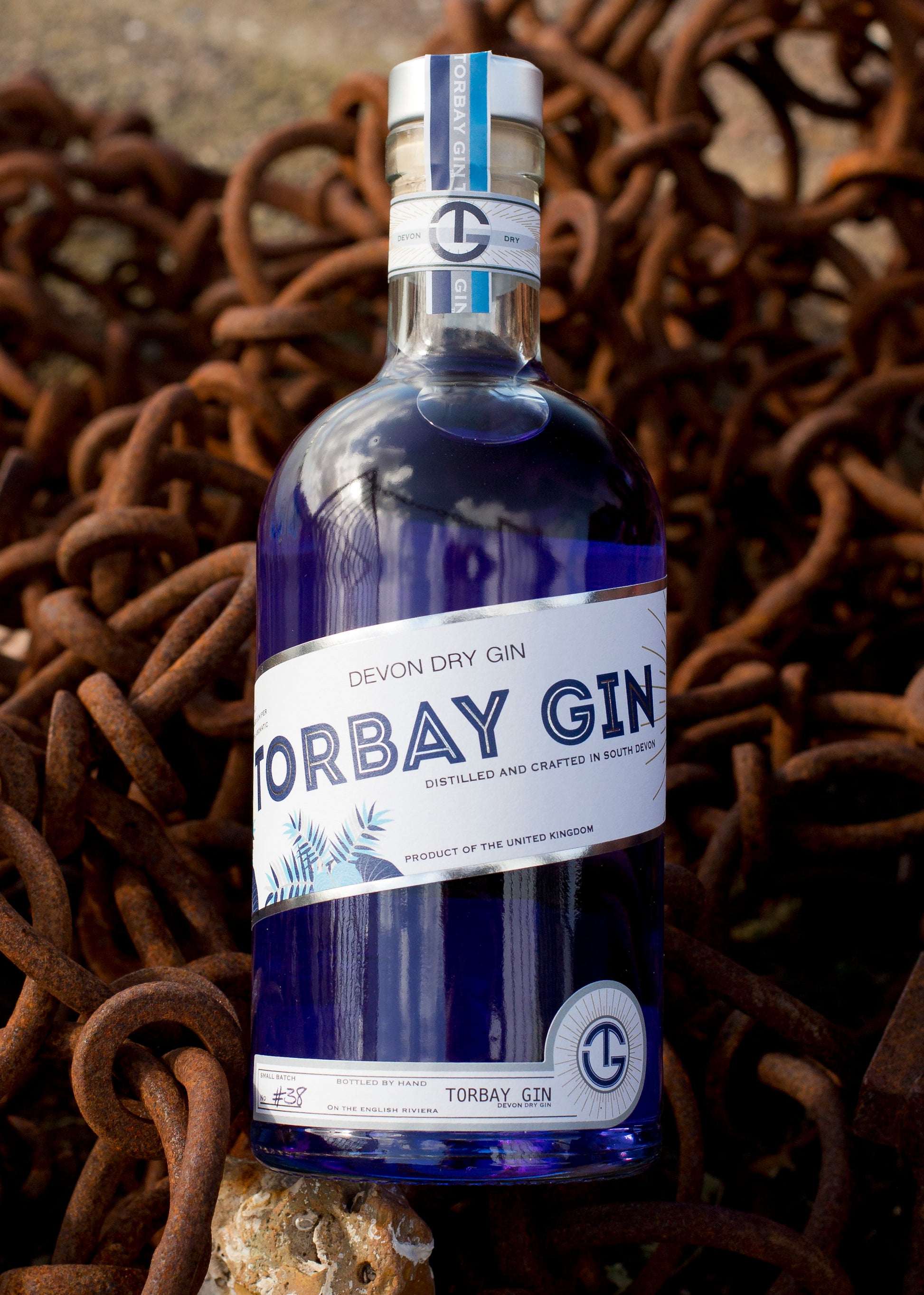 Bottle of blue torbay Gin with rustic background