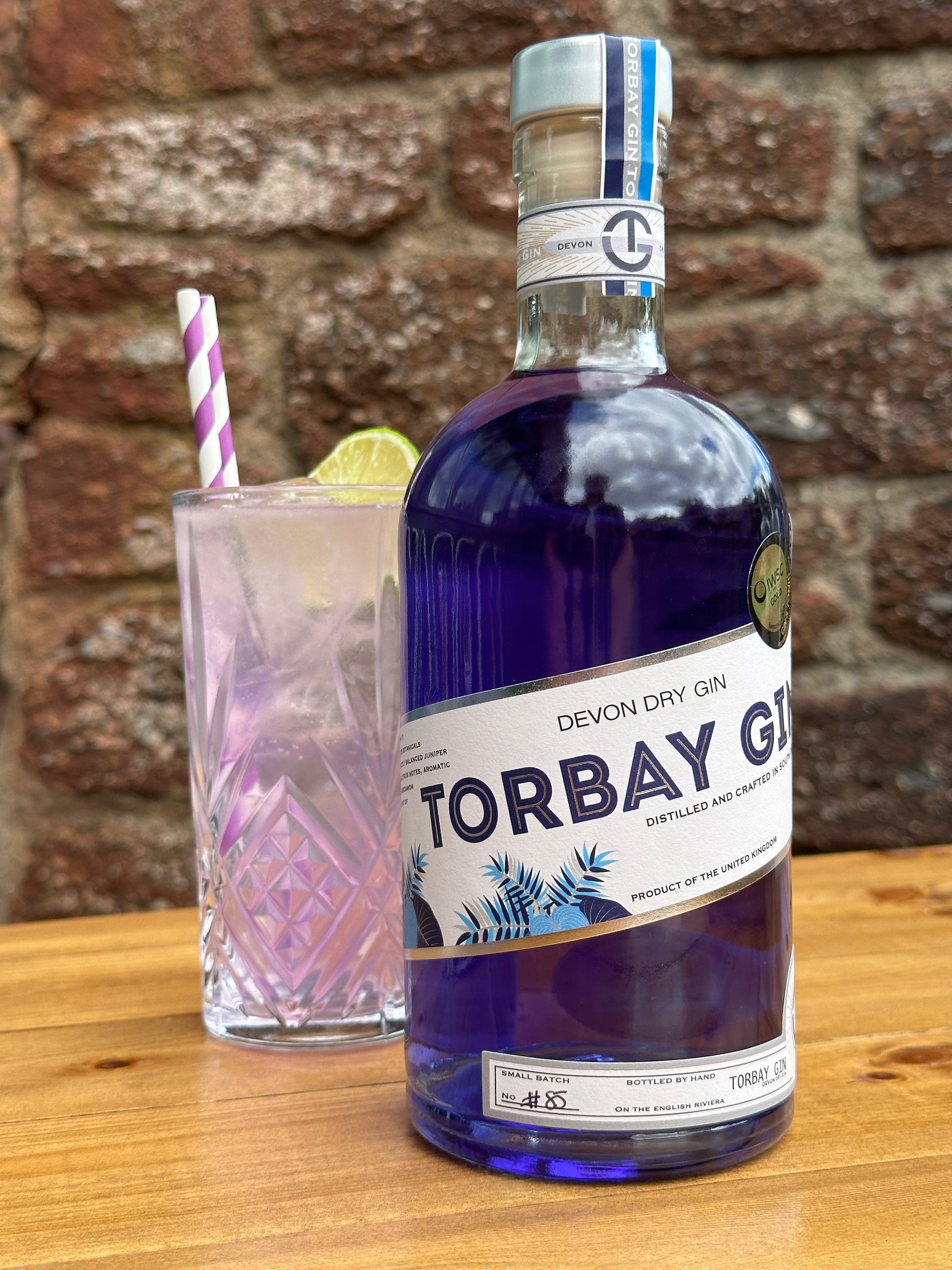 Torbay Gin in front of colour changing Torbay Collins cocktail